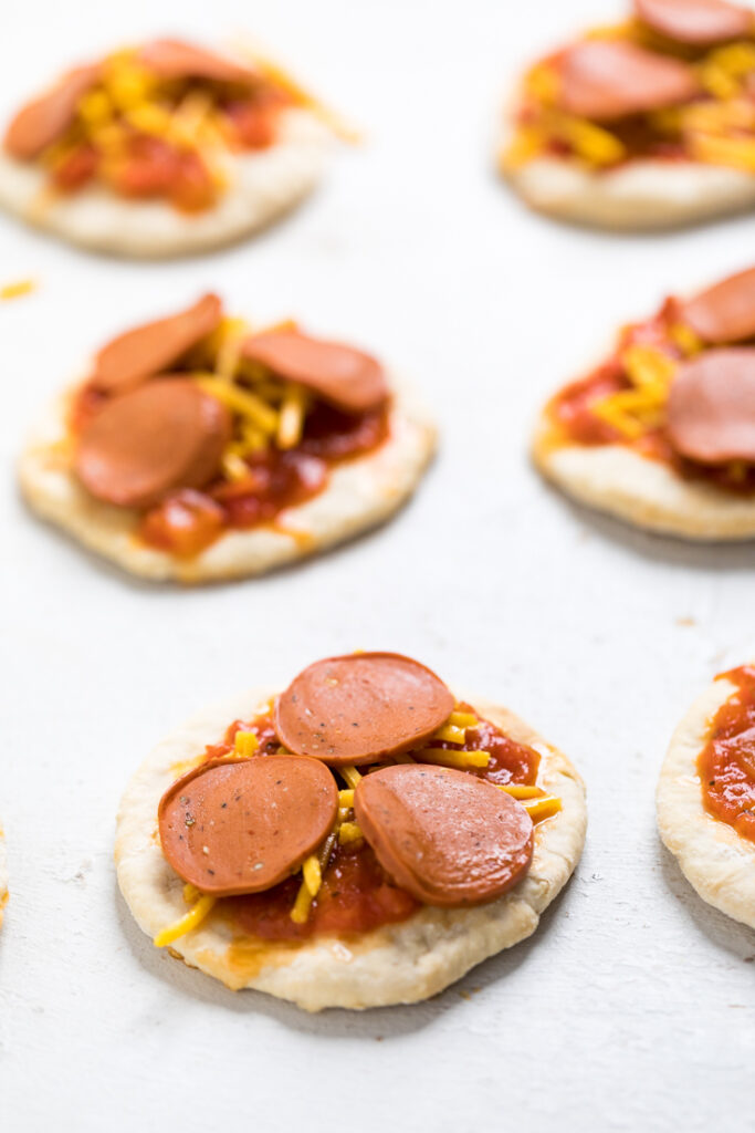 A table with premade 5 ingredient vegan pizza lunchables. 