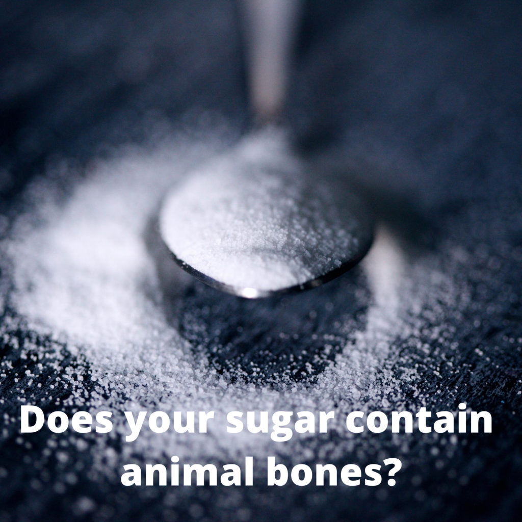 The words Does your sugar contain animal bones? overlayed onto a spoonful of sugar.