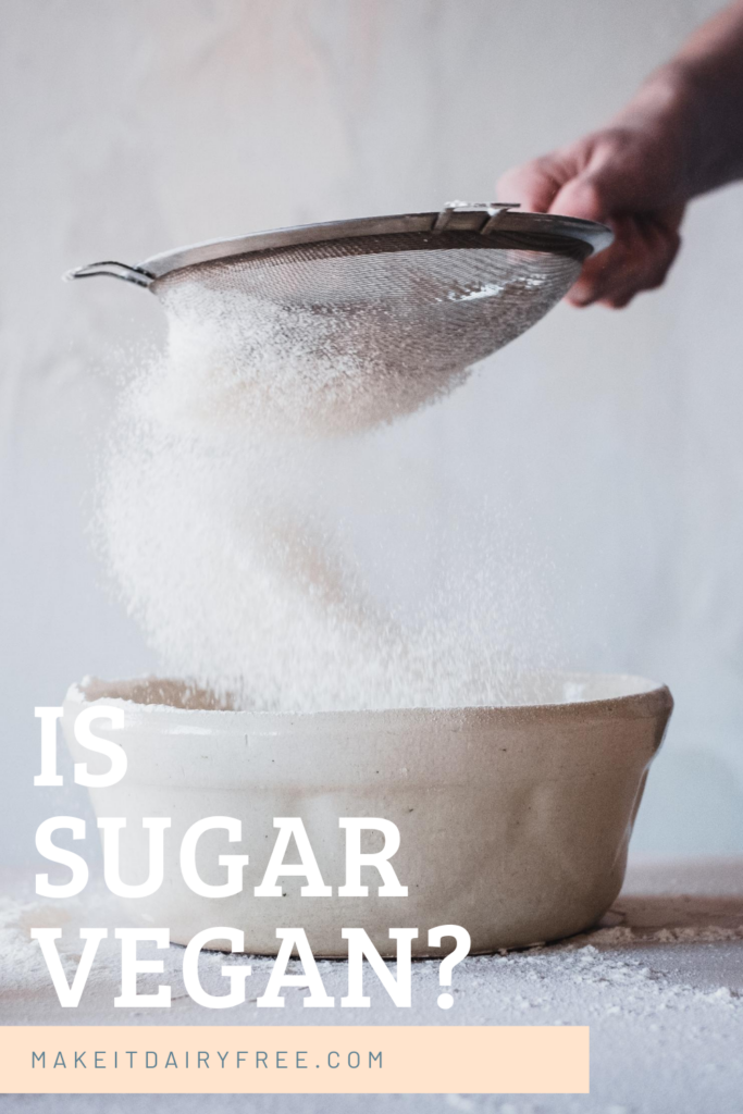 A sifter of sugar into a bowl with the words Is sugar vegan? overlayed.