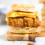 A Copycat Chick-fil-a Vegan Chicken biscuit sandwich on a board.