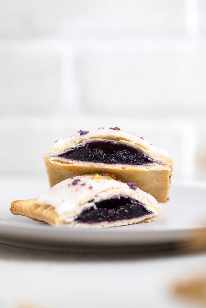 A vegan blueberry pop tart halved stacked on each other.