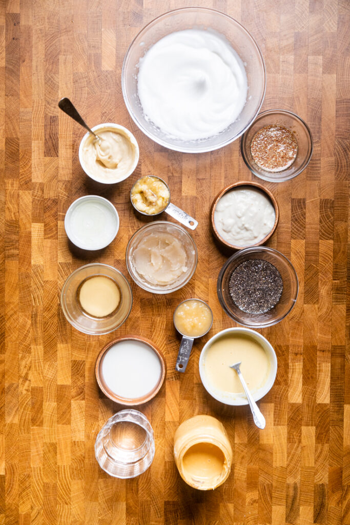 A variety of fifteen vegan egg substitutes on a table.