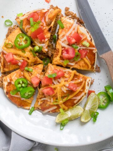 A vegan mexican pizza cut into slices.