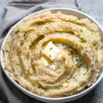 A serving bowl of One Pot 30 minute vegan mashed potatoes and gravy.