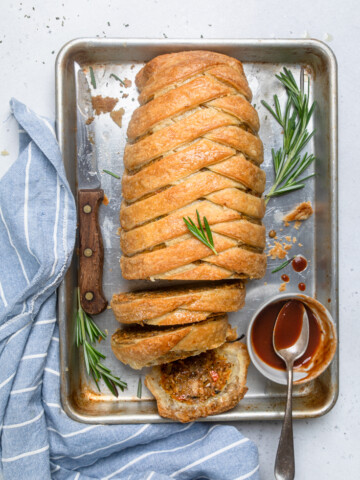 A tray of Mushroom Free Vegan Lentil Wellington with two slices cut.