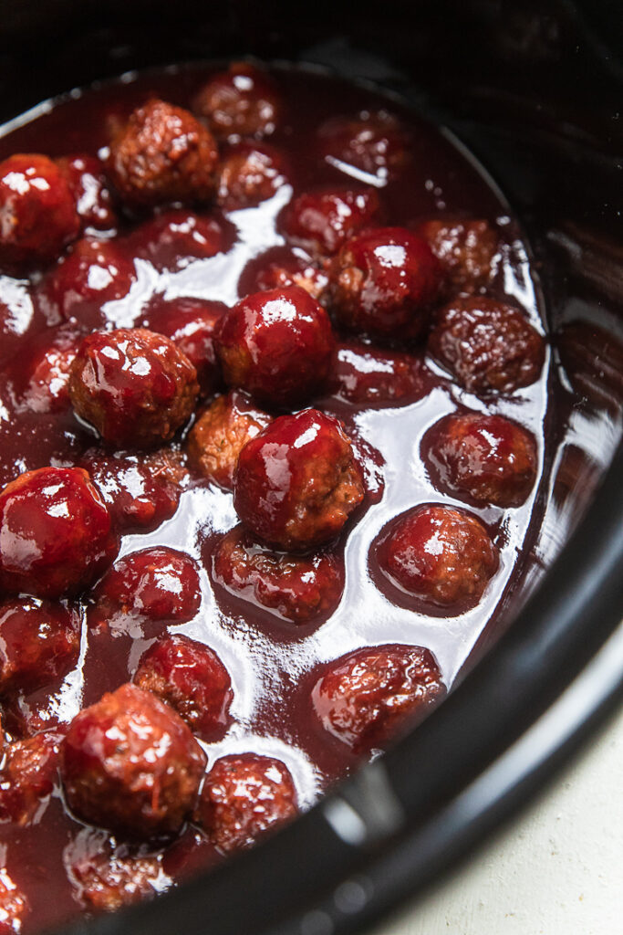 A skillet of vegan grape jelly meatballs.