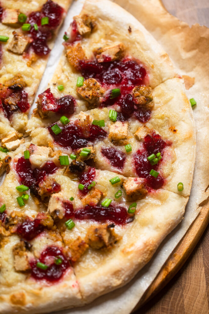 Vegan pizza made with leftover vegan turkey, mashed potatoes, cranberry sauce and green onions.