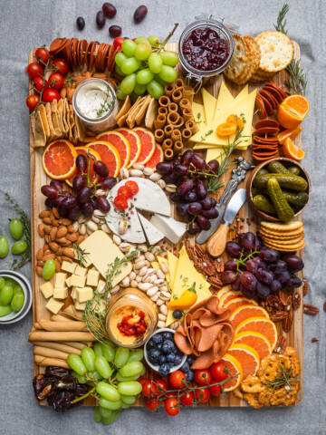 Vegan meats, cheeses and fruit arranged to make a Vegan Charcuterie Board.