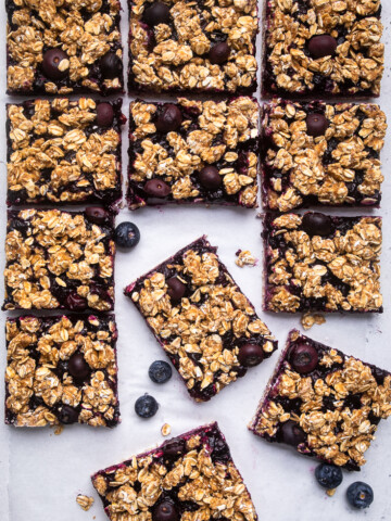 A batch of Vegan blueberry breakfast bars cut into squares.