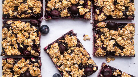 A batch of Vegan blueberry breakfast bars cut into squares.