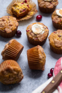 Vegan Cranberry Orange Muffins on a gray table.