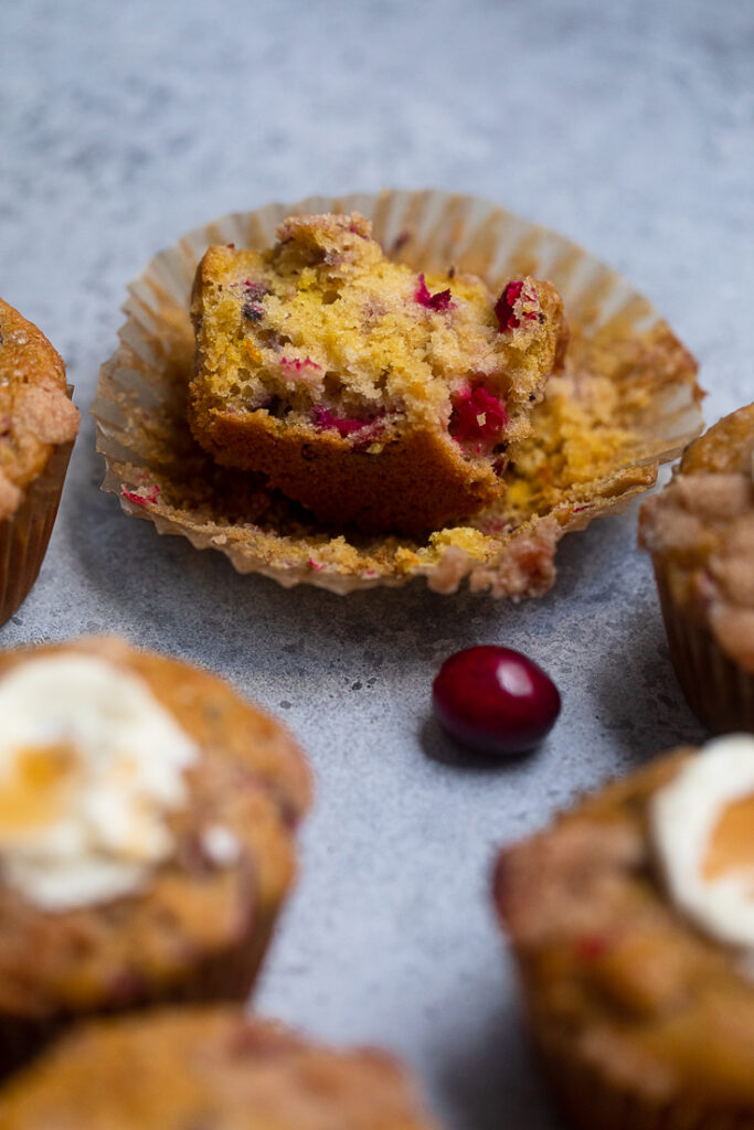 A halved Vegan Cranberry Orange Muffin to show fluffy texture.