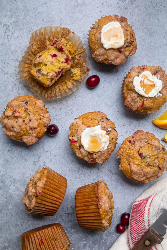 A few Vegan Cranberry Orange Muffins on a table.