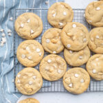A batch of Easy Vegan White Chocolate Macadamia Nut Cookies on a cooling rack.