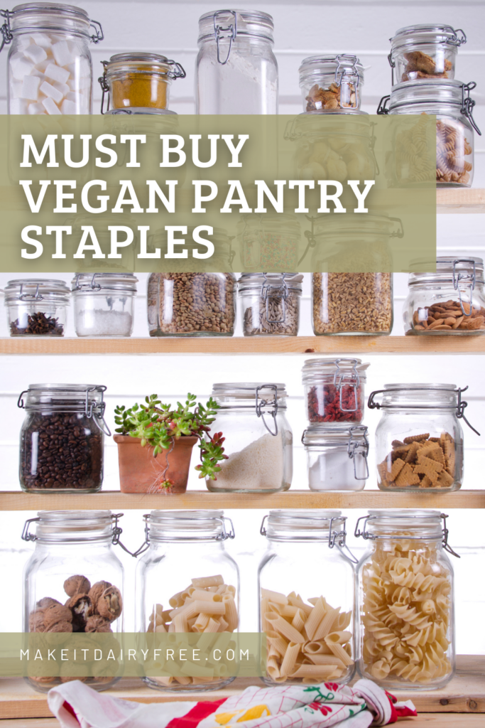 Pantry shelves with clear jars with the words Must Buy Vegan Pantry Staples overlayed.