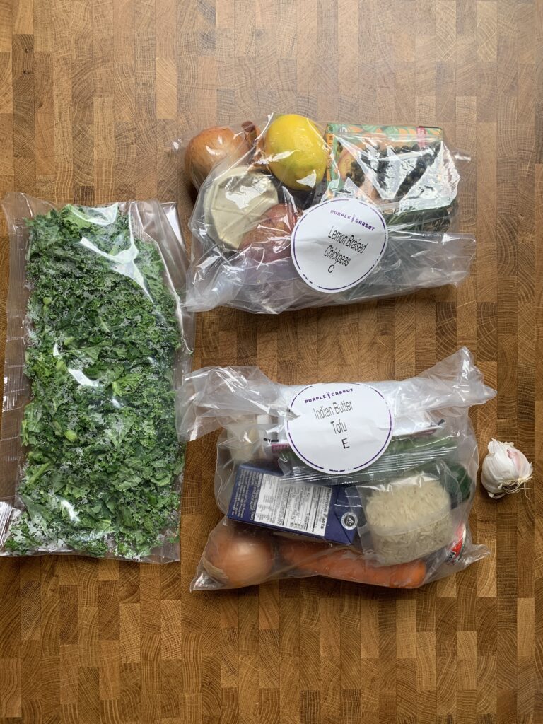3 bags of ingredients from Purple Carrot meal delivery service.