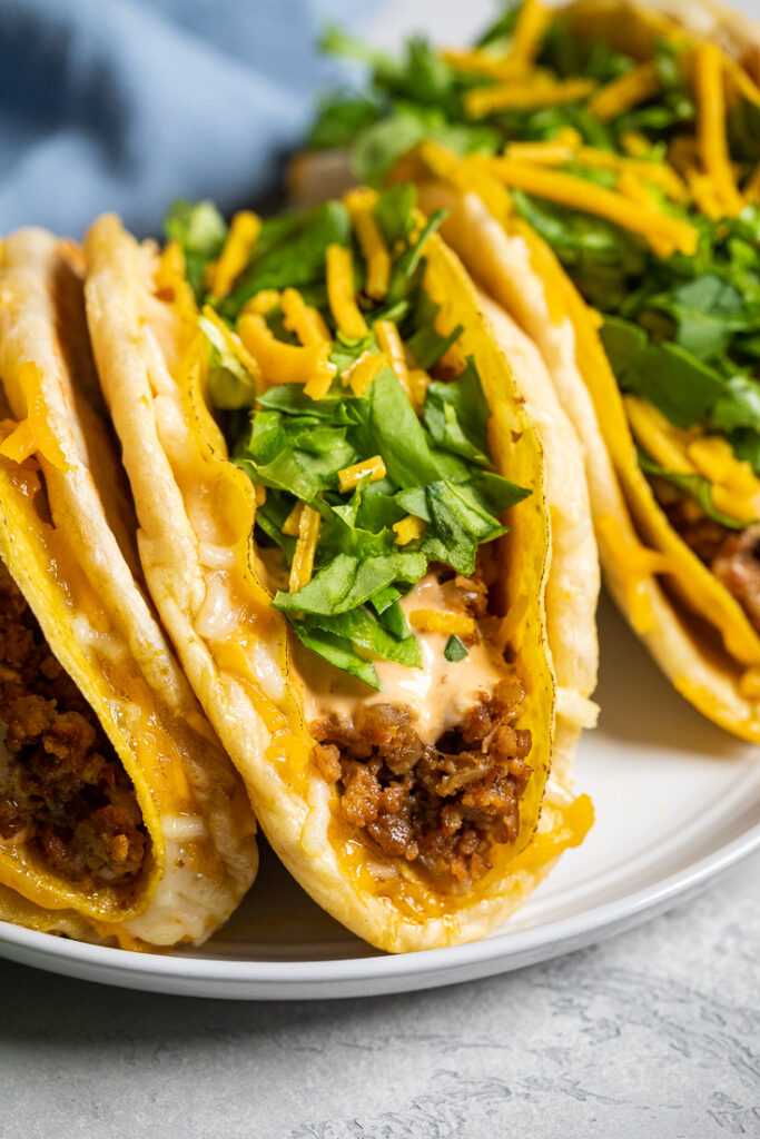Taco Bell copycat vegan cheesy gordita crunch tacos on a plate.