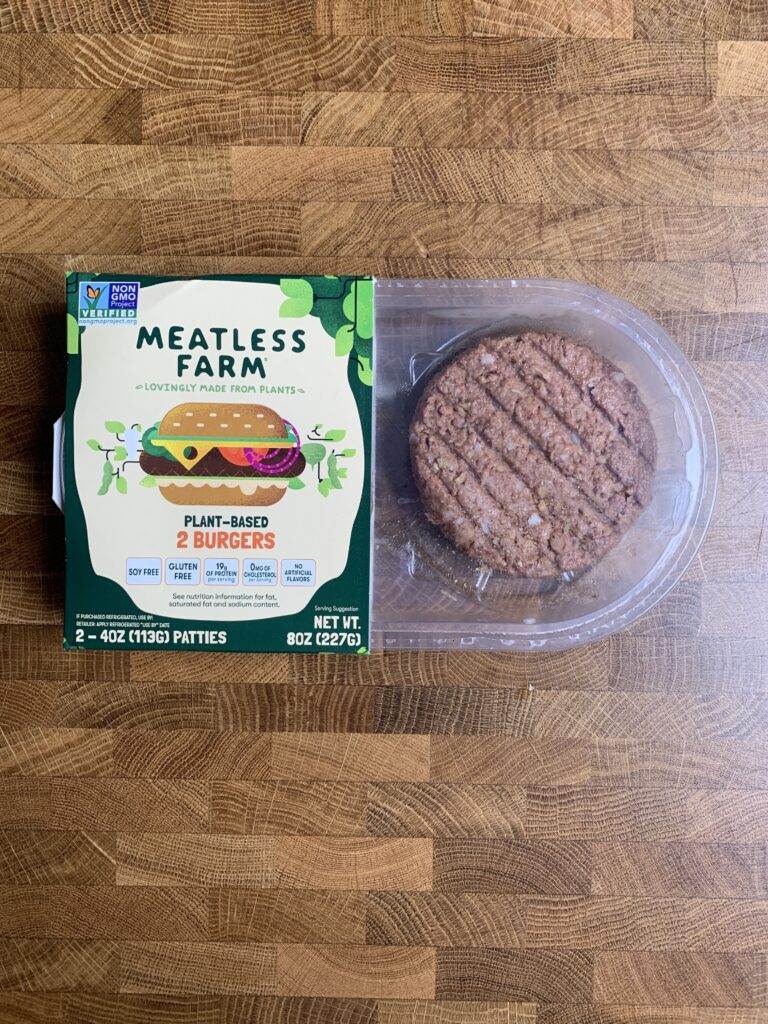 Meatless farm plant-based burger patties in package.