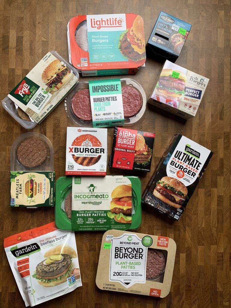 An assortment of vegan burgers on a wooden table.
