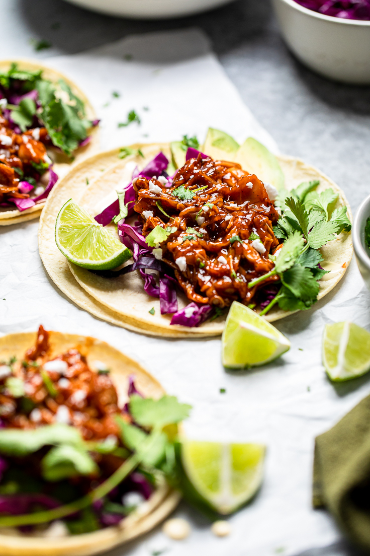 A grilled vegan jackfruit taco with cilantro and lime on corn tortillas. 