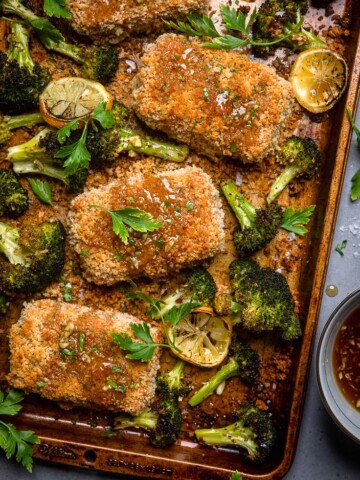 A baking tray of Vegan honey garlic oven fried tofu with roasted broccoli.