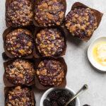 A batch of Gluten free vegan blackberry cinnamon muffins in brown muffin liners.