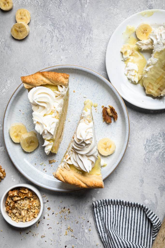 A plate with two slices of Vegan Banana Cream Pie. 