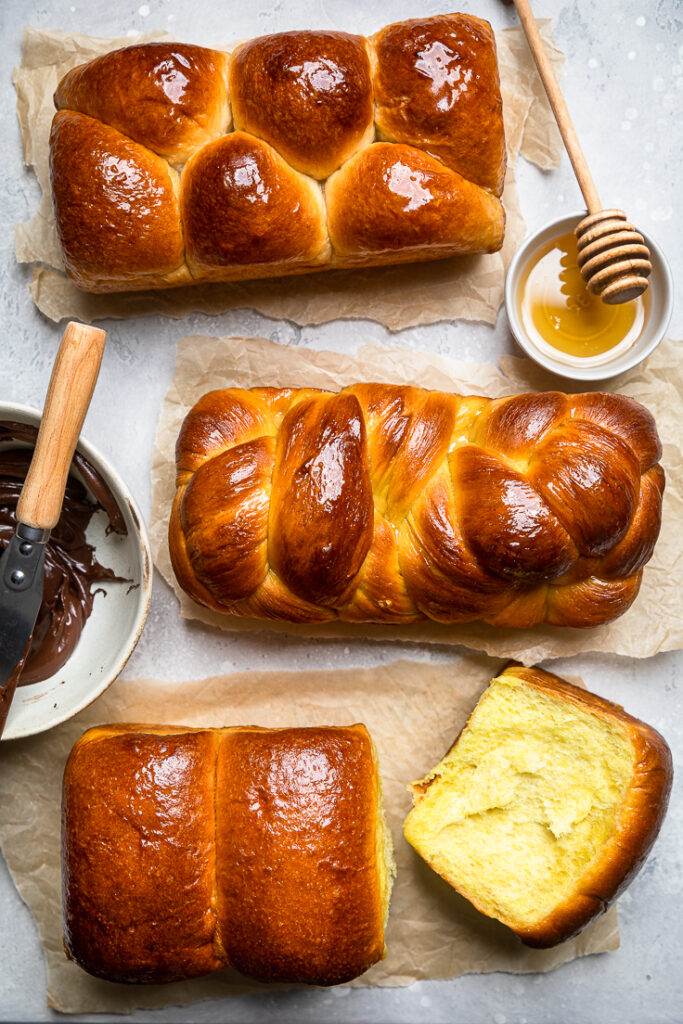 Vegan Brioche Bread loaves brushed with simple syrup.