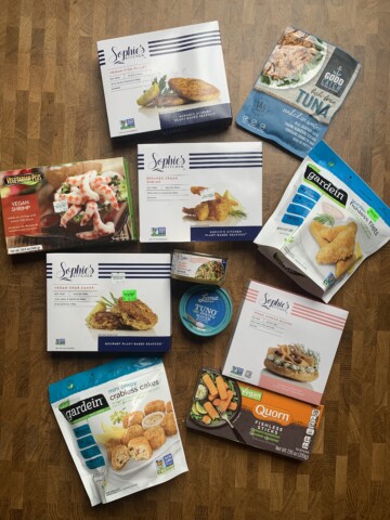 An assortment of vegan seafood products in packages on a table.