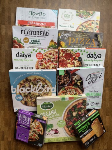 An assortment of vegan frozen pizzas boxes.