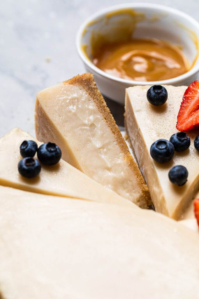 The side of a slice of incredible vegan cheesecake to show creamy texture. 