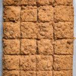 A tray of vegan coffee cake cut into squares.