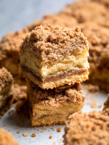 A side view of stacked vegan coffee cake to show fluffy cake texture with crumbly topping.