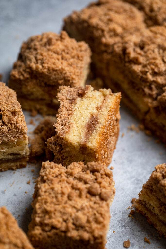 A side view of a piece of vegan coffee cake to show fluffy cake texture.