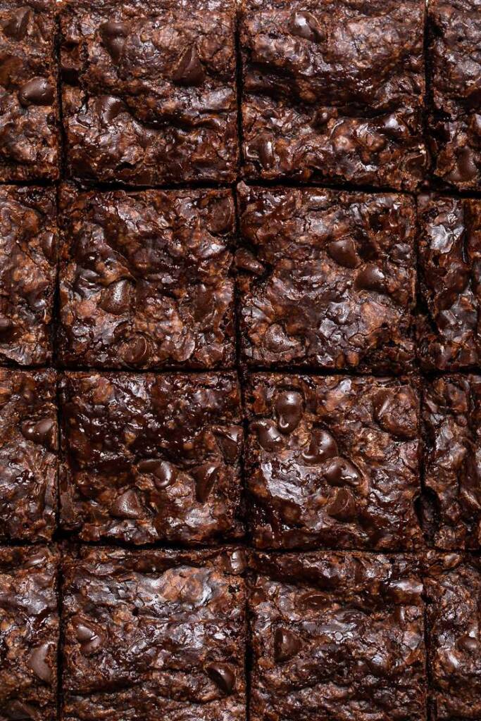 The best vegan brownies cut into squares with gooey melted chocolate chips.