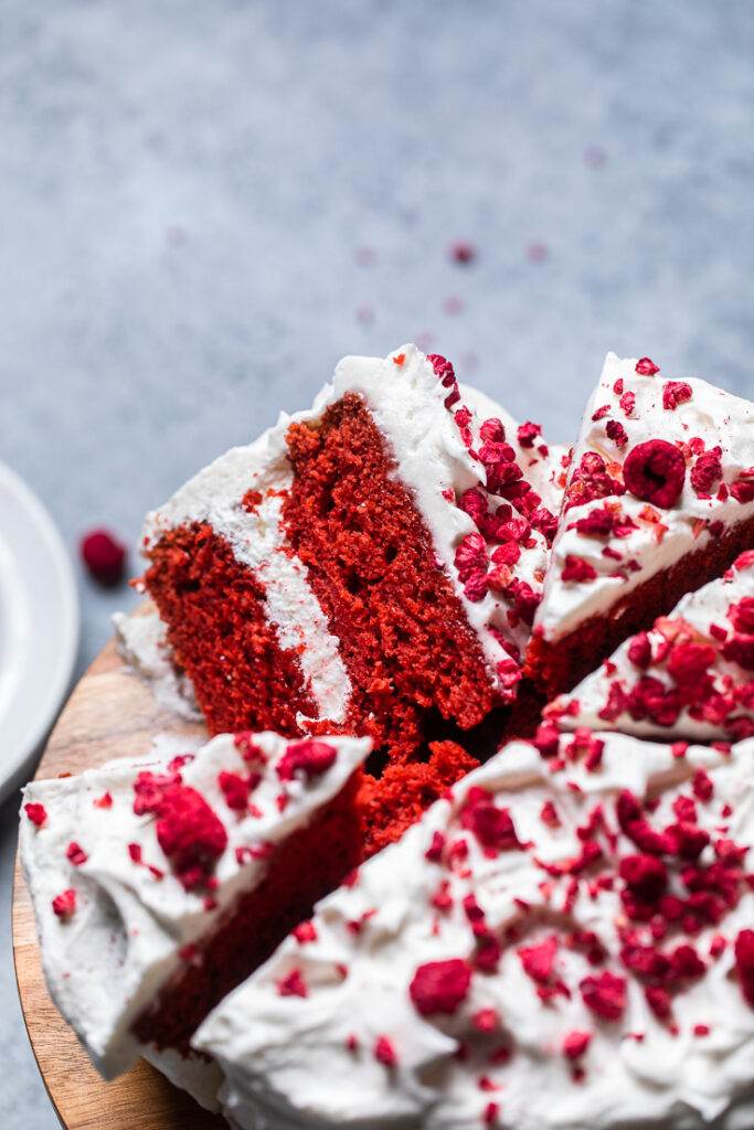 The inside fluffy texture of a slice of a vegan red velvet cake.
