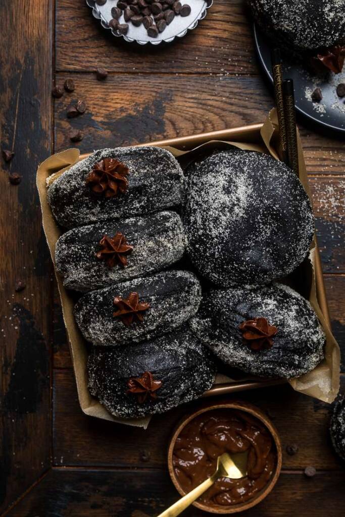 Black Chocolate Brioche Donuts with chocolate cream frosting swirled out the top. 