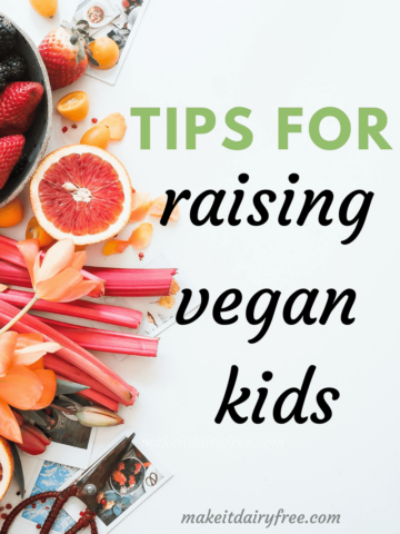 The words Tips for raising vegan kids overlayed on a variety of fruit.