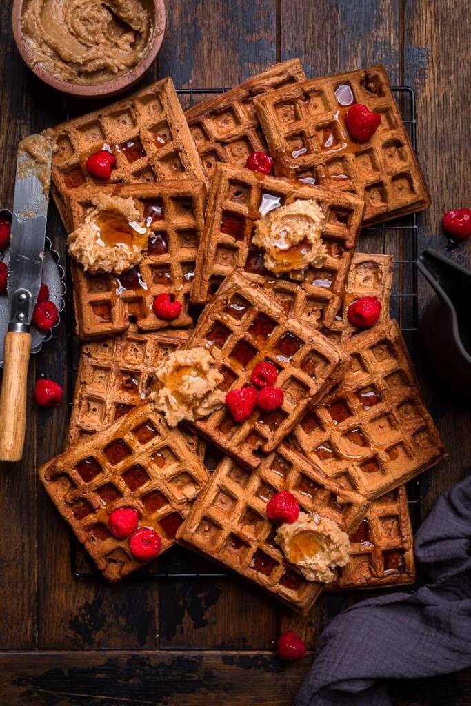 vegan chocolate pumpkin waffles with raspberries and cinnamon butter.