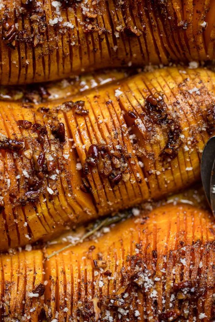 Slices of Vegan Hasselback squash with butter topping.