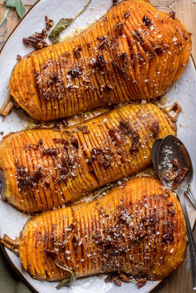 Three pieces of Vegan Hasselback squash with pecan butter topping. 