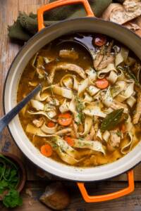 A dutch oven filled with homemade vegan chicken noodle soup.