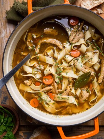 A dutch oven filled with homemade vegan chicken noodle soup.