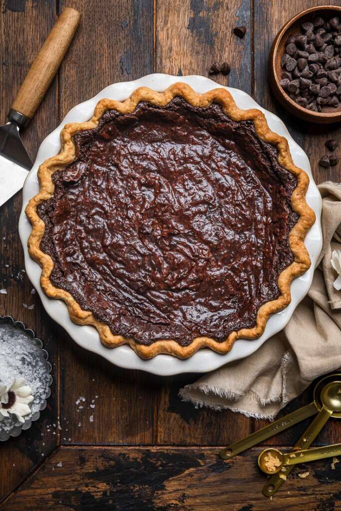 Cooked vegan molten chocolate pie in a white pie dish uncut.