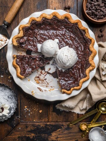 Molten vegan chocolate pie with vegan ice cream on top and slices removed.