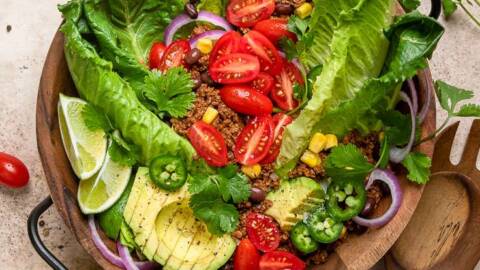 A wooden bowl of vegan taco salad.