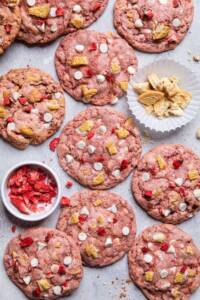 Pink Vegan strawberry shortcake cookies with white chocolate chips and vanilla cookie pieces.
