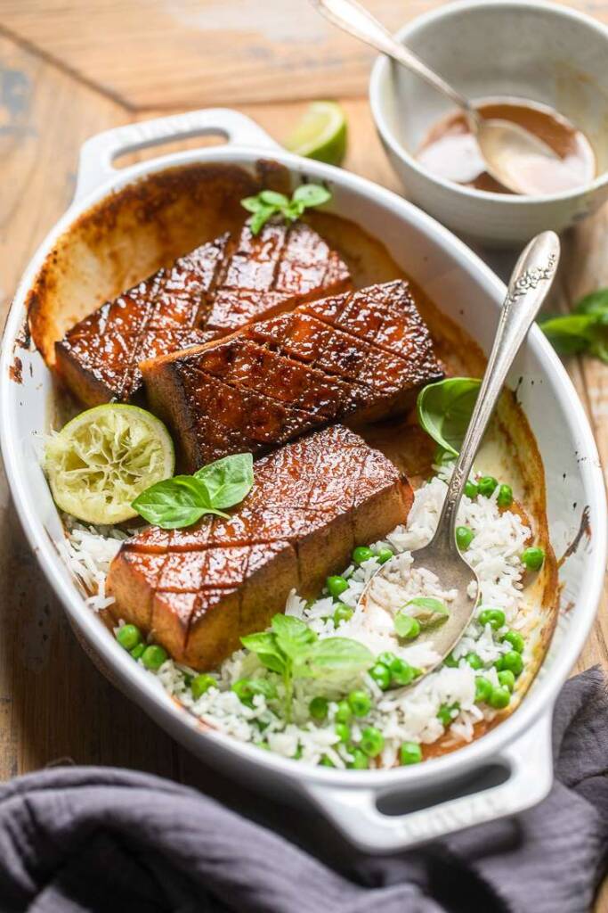 A bowl of brown sugar glazed tofu with rice and peas. 