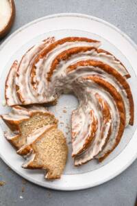 Vegan banana bundt cake with icing and two slices cut.