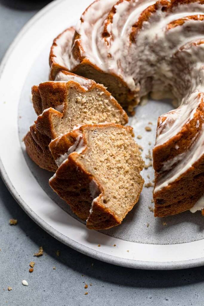 two of Vegan banana bundt cake with thick glaze over the top. 